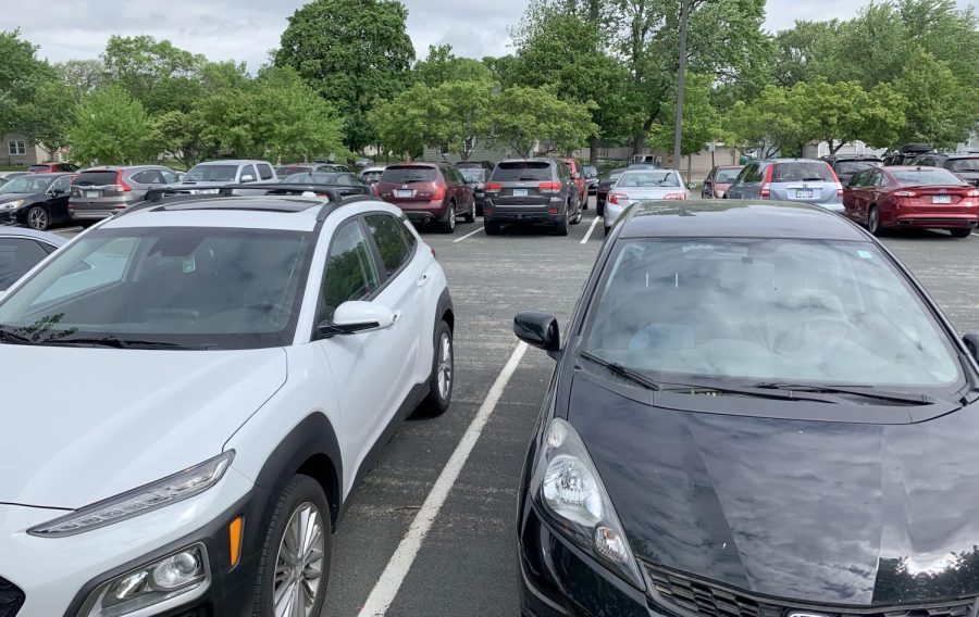 Cars sit in a crowded lot June 3. There has recently been a lack of enforcement for the parking passes.
