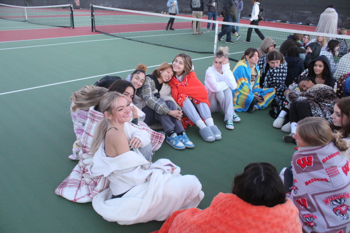 Seniors sit on the tennis court with each other to see the sunrise. The event started at 6:20 a.m. at the high school on Sept. 22.