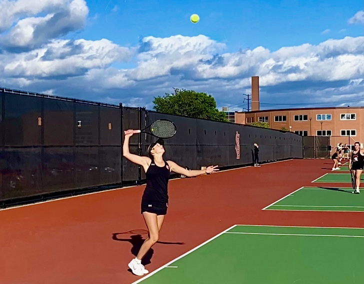 Senior Sadie Lund prepares to serve ball to opponent Wednesday Sep. 21. Park ended up winning the match 7-0.