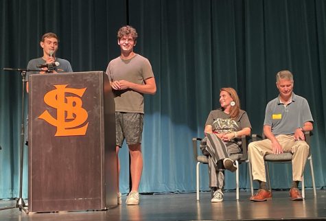 Seniors Sebastian Tangelson and Isaac Israel talk with guest speakers Larry Kraft and Peggy Flanagan Sept. 20. The voter registration assembly encouraged students to become civically engaged.