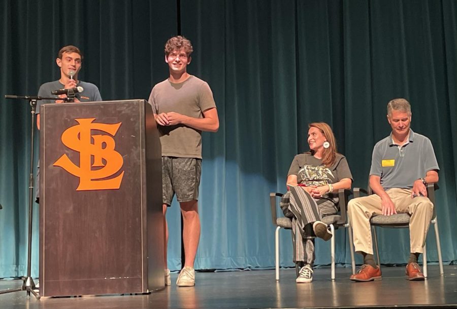Seniors Sebastian Tangelson and Isaac Israel talk with guest speakers Larry Kraft and Peggy Flanagan Sept. 20. The voter registration assembly encouraged students to become civically engaged.