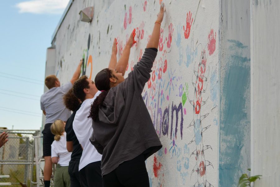 Senior Shantell Harden paints her handprint on the wall Sept 30. Students were able to paint Sept. 29 and 30.