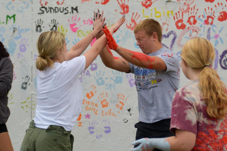 Seniors Henry Bendickson and Anna Becker give each other a high five. Class of 2023 chose to paint a silhouette of Michael Jordan.