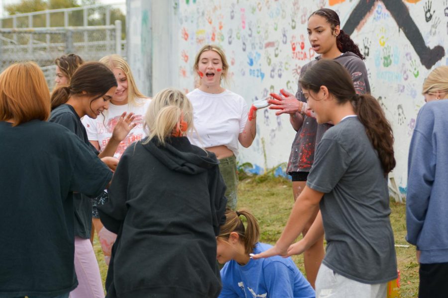 Seniors gathered to paint the wall Sept. 30. Students organized to bring paint for the mural.