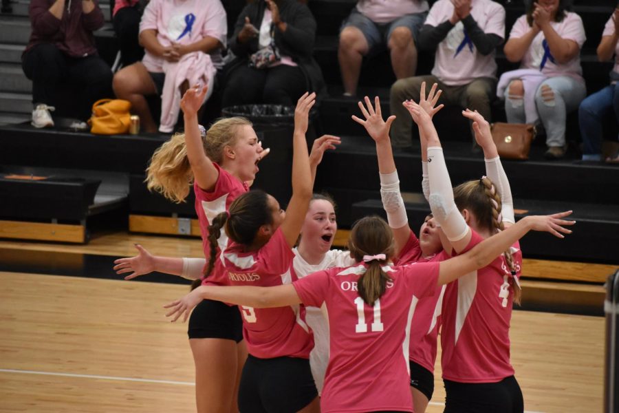 Junior Addison Chenvert celebrates with her teammates Oct. 10. The team was playing in honor of Breast Cancer Awareness Month.