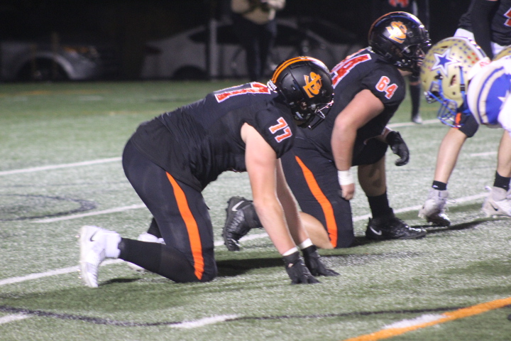 Senior Zach Johnson kneels in the line Oct. 7.  The team faced off against Holy Angels for the Homecoming game.