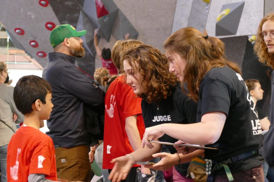 Seniors Samantha Coggan and Cece Jensen volunteer to judge climbers Oct. 29. Vertical Endeavors held their Octboulder Fest, where climbers competed on bouldering.