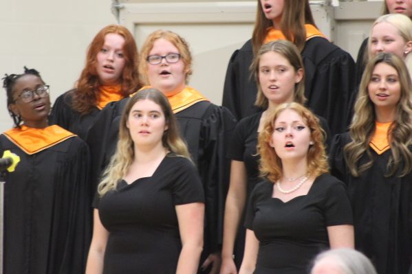 Senior Rose Huse sings along with fellow choir members at the choir concert. The choir concert was held Oct. 27 in the fieldhouse. 