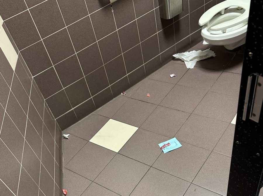Candy wrappers and tissues are scattered on the floor in a bathroom stall Nov. 29. Park has had a concerning rise in littering.
