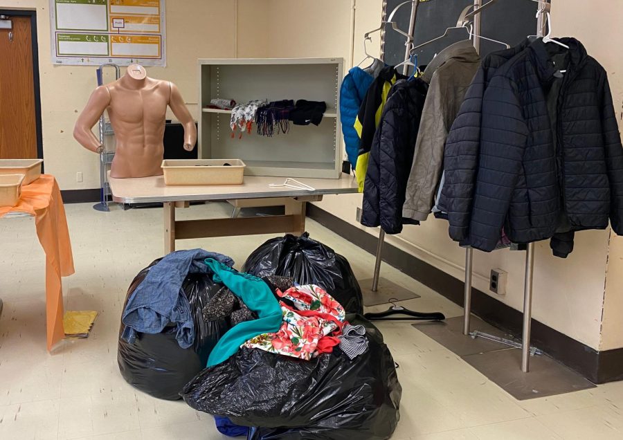 Students stock the clothing closet with winter gear. The clothing closet is open for all students during fifth hour, Mondays through Fridays, in B226.