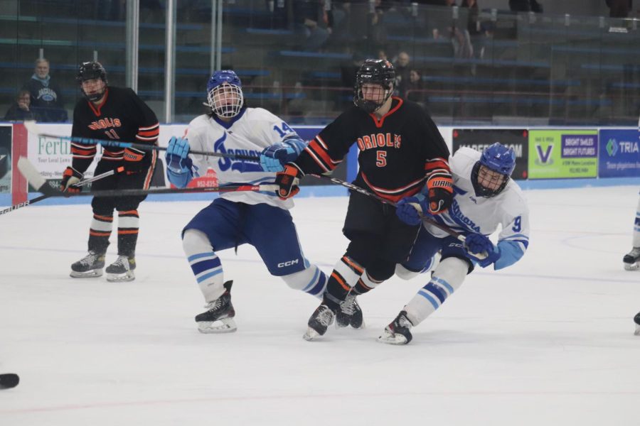 Sophomore Max Rider faces resistance as he skates up ice for the puck. Park took on Jefferson Jan. 10.