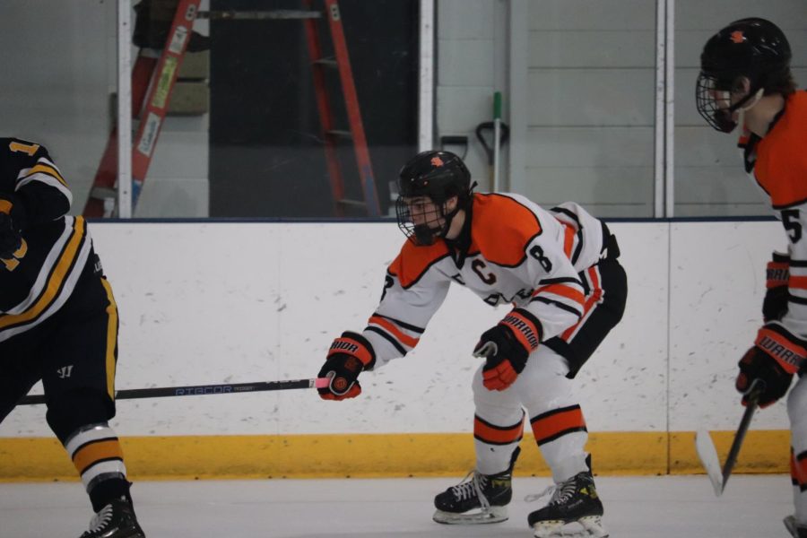 Senior Teddy Dahlin reaches for the puck on defense. The Orioles took down the Eagles Dec. 28.