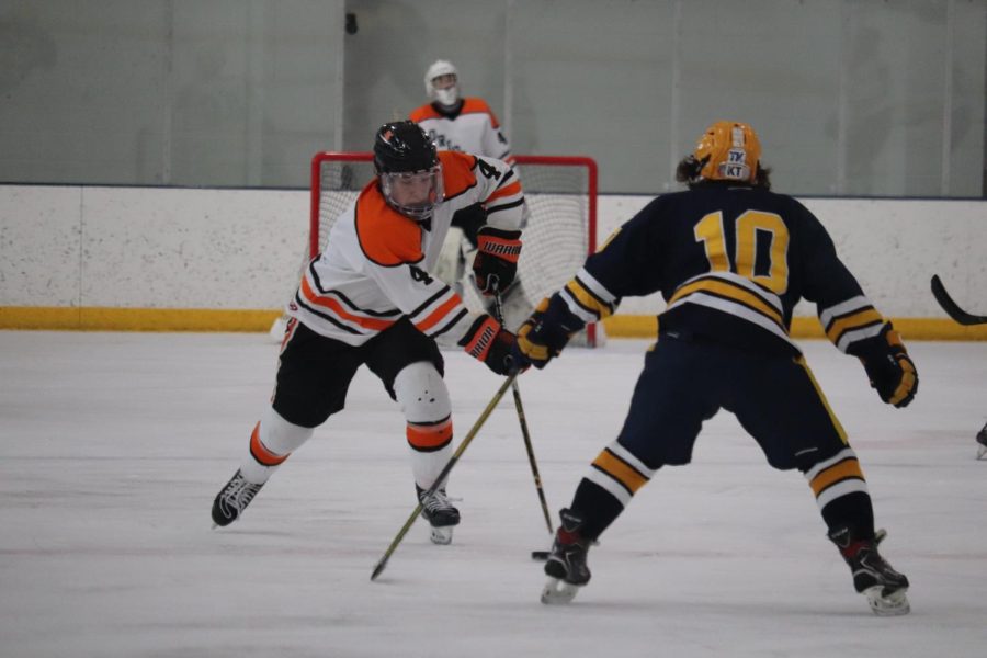Junior Griffin Krone passes the puck to his teammate as they head to the net. The Orioles beat the Eagles 9-1 Dec. 28.