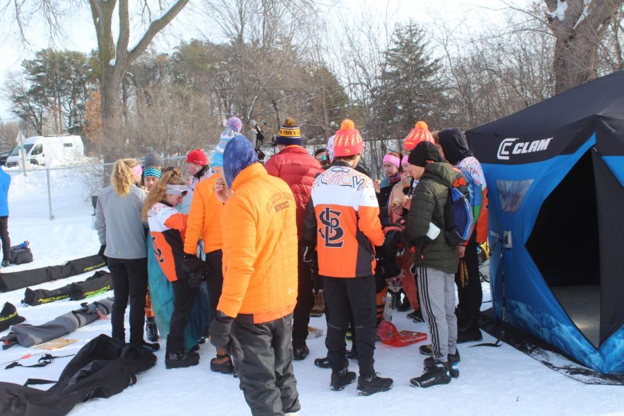 Park skiers have a team meeting after a morning of races January 14. Park finished third in two races.