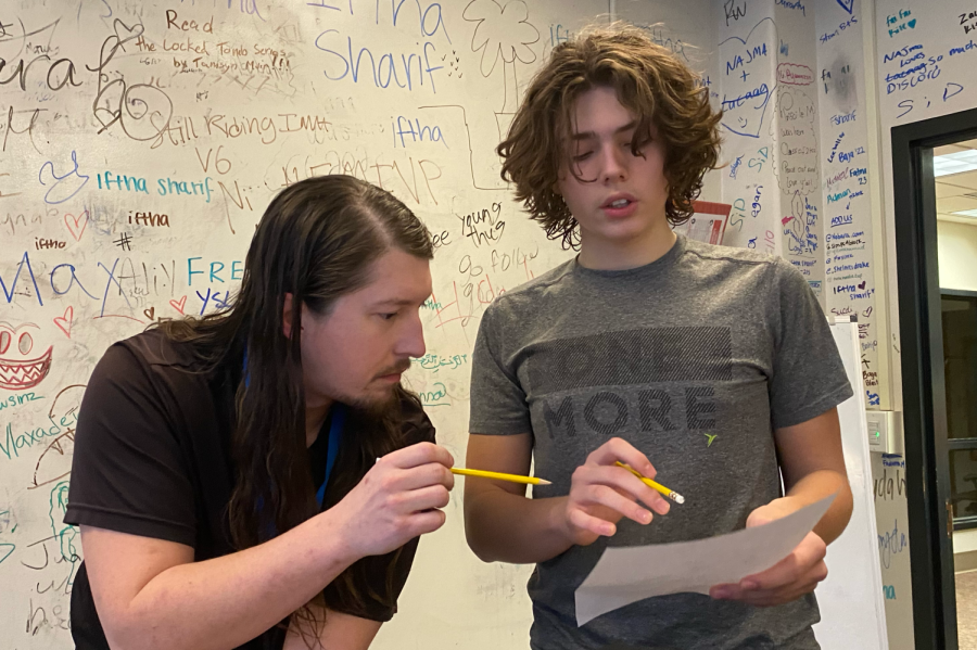 Mr. Aaron helps freshman Owen Hollinger with his geometry homework. Mr. Aaron works as a math tutor and helps students with various levels of math.