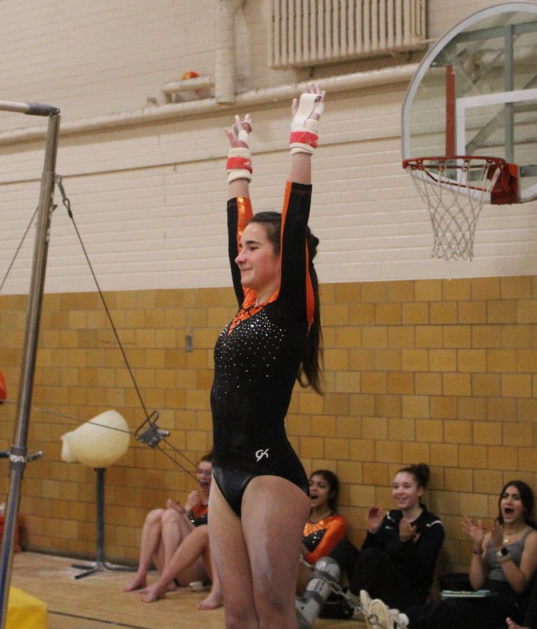 Freshman+Veronica+Jones+salutes+the+judges+after+finishing+her+routine+on+uneven+bars%2C+Jan.+10.+