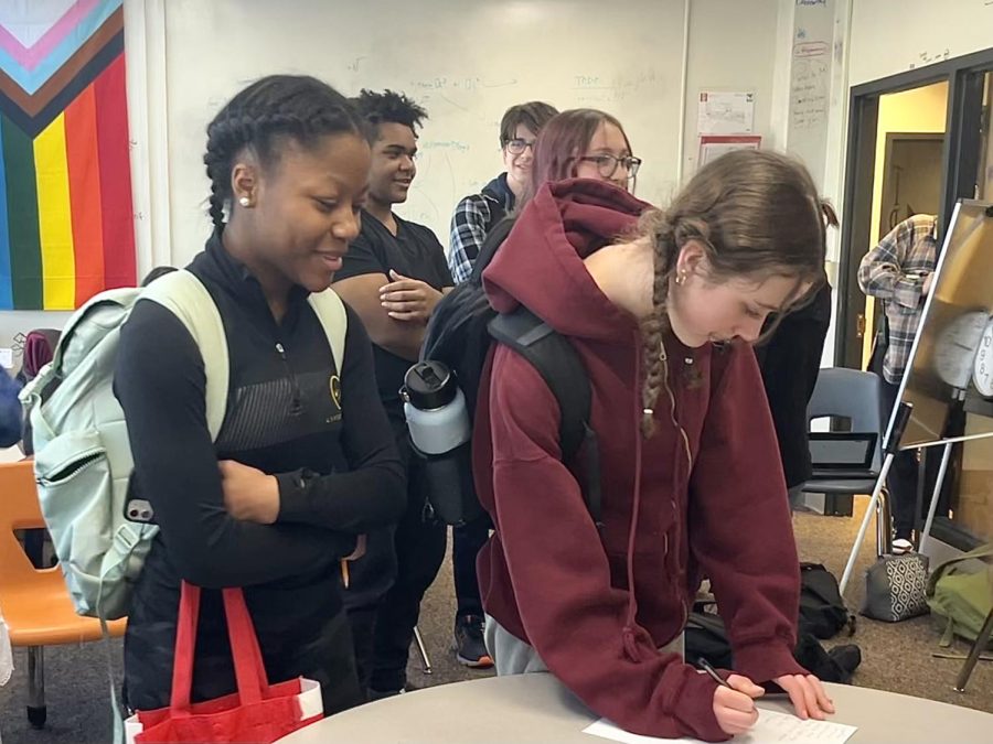 Freshmen Lily Anderson and Makenna Allison sign in to the informational dance team meeting Feb. 10. At this meeting they learned and asked questions about the potential Park dance team.