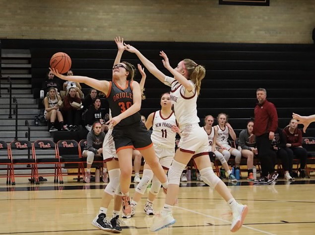 Junior Evelyn Schmitz drives to the hoop, as she attempts a layup Feb. 18. Schmitz leads the Orioles in points this year with 280.