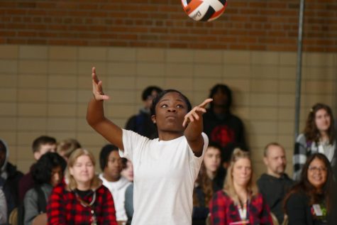 Sophomore Denea Lewis goes to serve the ball Feb. 10. Students were defeated when teachers achieved 25 points first.