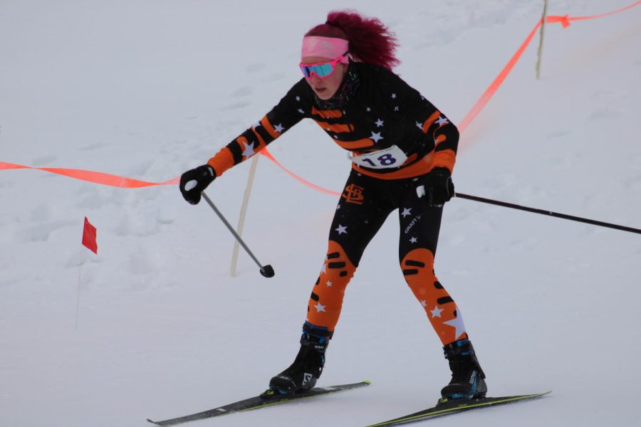 Junior Addison Chenvert finishes up the second leg of the relay race Feb. 15. Chenvert worked on advancing on the final downhill of the second leg.
