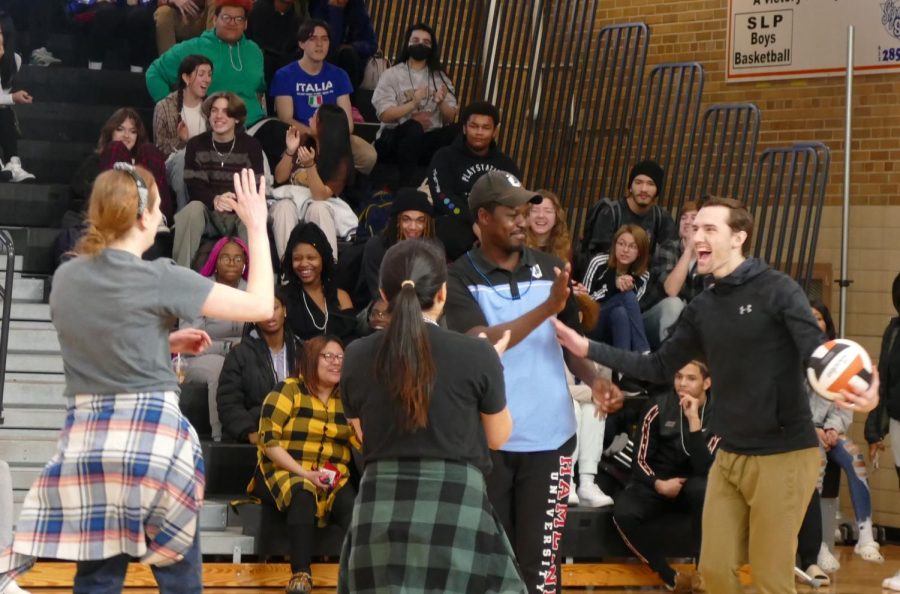 Teachers celebrate with each other after gaining the lead Feb. 10. The teachers won in the staff vs student game.
