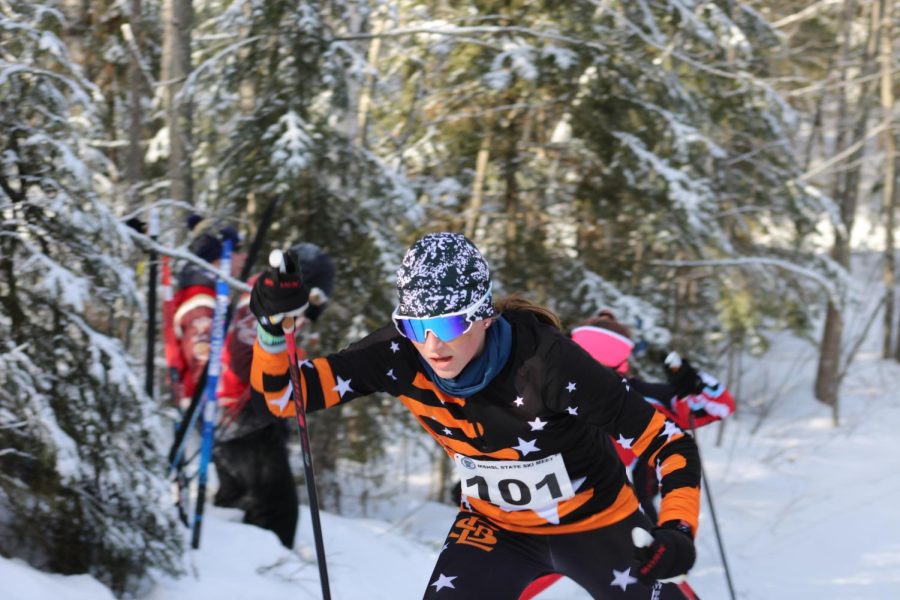 Freshman Kaylee Crump skis up a hill in the skate ski race Feb. 16. Crump was 103rd place overall at state.