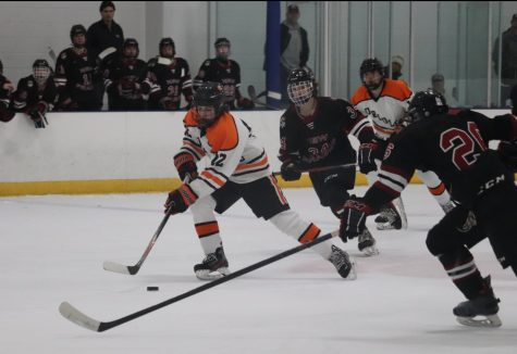 Sophomore Trevor Moran handles the puck as he skates up the ice. In their second match-up of the season, Park defeated New Prague 4-2 Feb. 14.