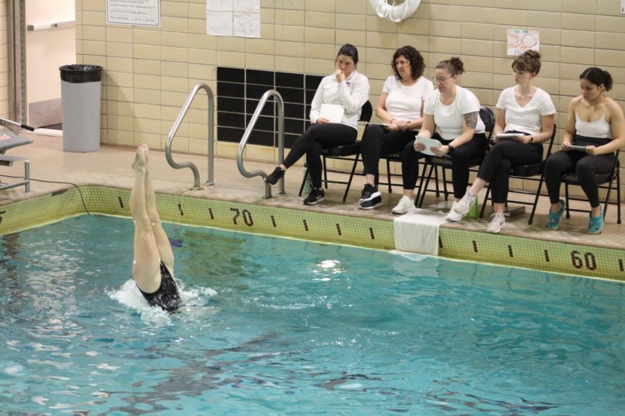 Synchronized swimming judges look on as senior captain Rachel Katzovitz performs her walkover figure March 23. Katzovitz ranked first place at the meet Thursday.