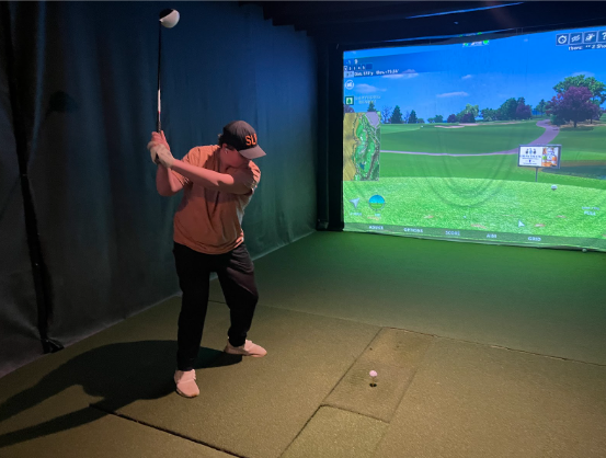 Junior Landon Tasto winds up for amazing swing at golf practice. Practice was held at the indoor golf course Inside Edge Golf 3/27/23 
