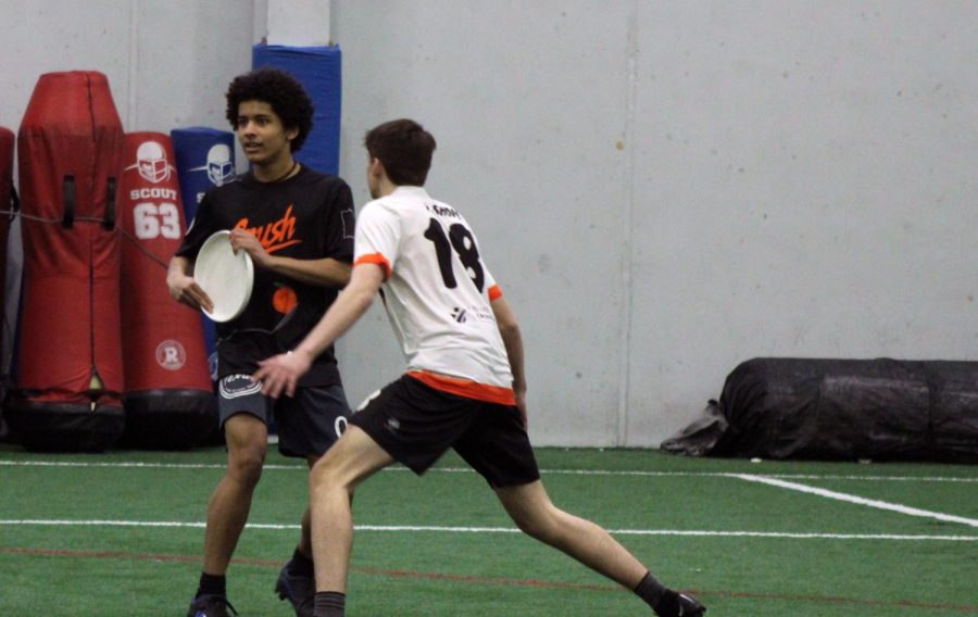 Junior Thomas Shope blocks senior Ryan DuSaire while scrimmaging March 25. This was the first varsity Ultimate practice of the season. 