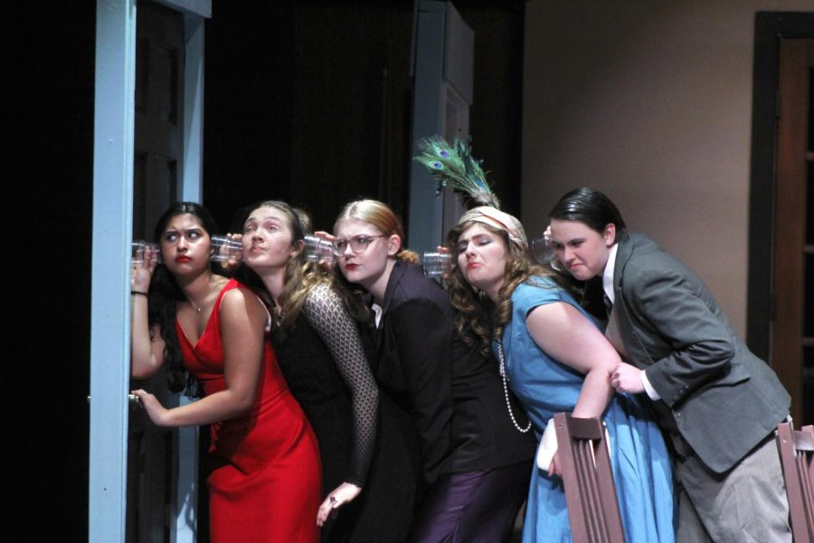 Five of the six dinner guests attempt to listen to what is happening on the other side of the door April 27.  Parks portrayal of the tantalizing murder–mystery “Clue” marks the end of the theatrical school year.