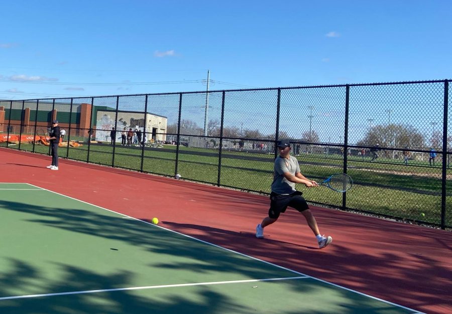 Senior captain Sam Wolden hits the ball to a Hopkins player in the second match of the season. The match was April 17 at the St. Louis Park tennis courts.