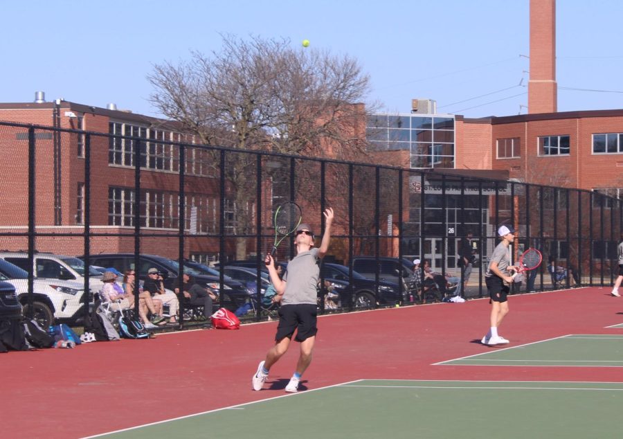 Sophomore Thomas Halverson serves the ball to Chanhassan at the first match of the season. The match was on April 13 at the high school’s tennis courts. 