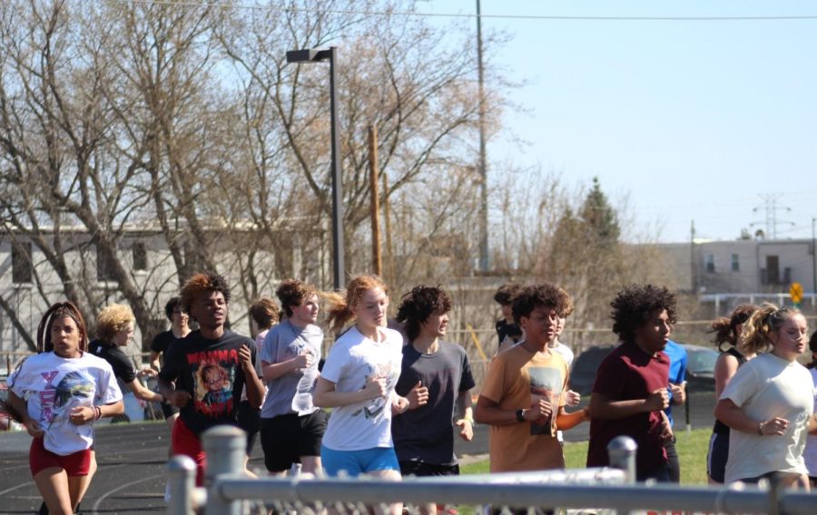 The track team warms up April 13. The team is unable to host meets this season.