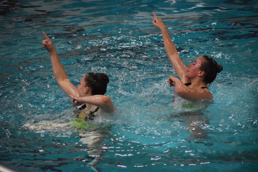 Senior Rachel Katzovitz and junior Mae Turman perform their routine May 17. Synchronized swimming commemorated the end of the regular season with a large razzle dazzle event Wednesday.
