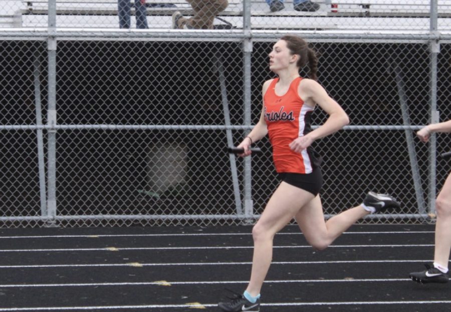Sophomore Anna Healey darts past opponents in the 4x100 relay race. Park’s girls relay placed fifth out of 10th.