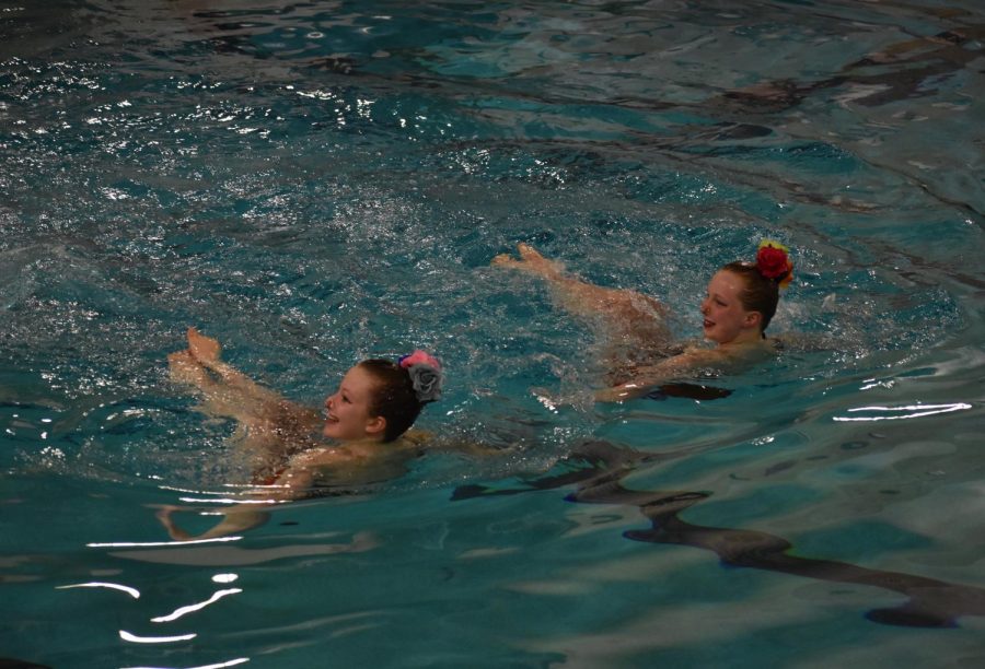 Junior Avery Courneya and middle-schooler Indigo Schoneman do their duo routine on May 17. Parks synchronized swimmers held an end-of-year performance Wednesday.
