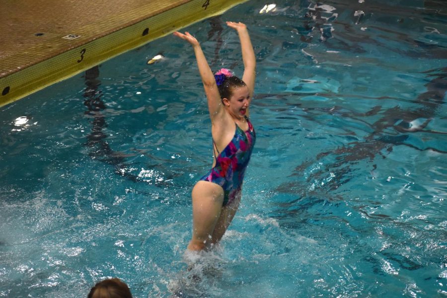 Middle-schooler Indigo Schoneman reaches in the air in the short teams event on May 20. The synchro team placed first in all but two events at their sections meet on Saturday.