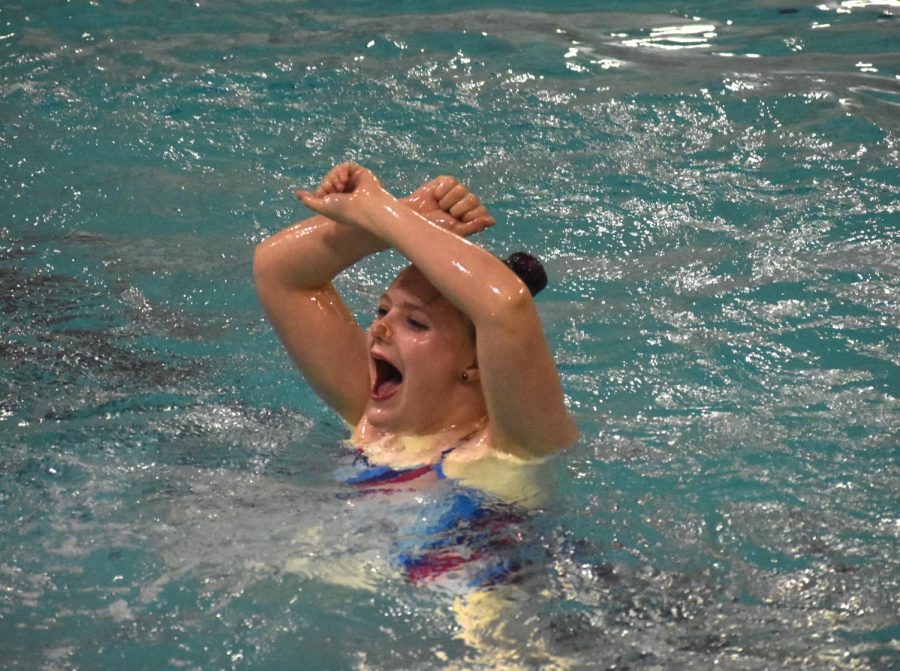 Sophomore Charlotte Cox performs her  solo routine the evening of May 17. Cox participated in several routines for the synchronized swimming event Wednesday. 