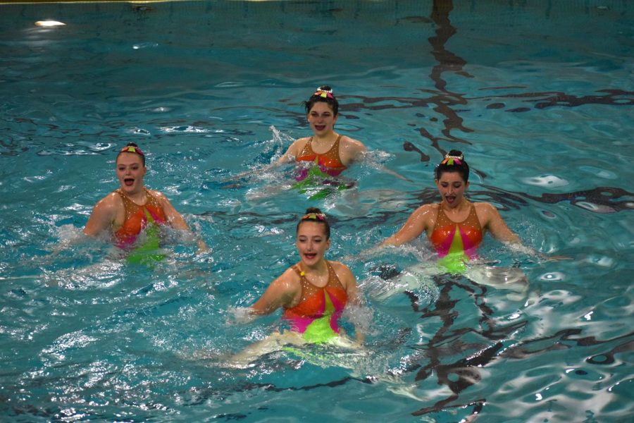 Clockwise from left: sophomore Charlotte Cox, freshman Lexa Rischall and middle-schoolers and Elena Mutchler and Lauren Hoag look at a judge during their long teams event on May 20. The synchro team beat Edina at sections for the first time since 2019 on Saturday.
