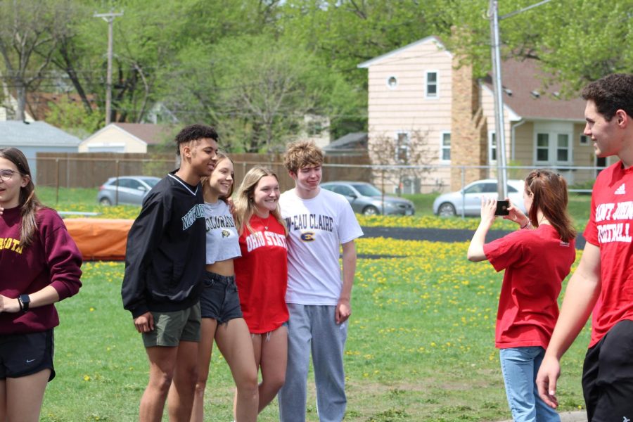 Seniors Kwame Fokou, Sophia Nagorski, Anna McCallon and Dylan ODea pose for a picture by the track. The class of 2023 celebrated their college decisions May 11.