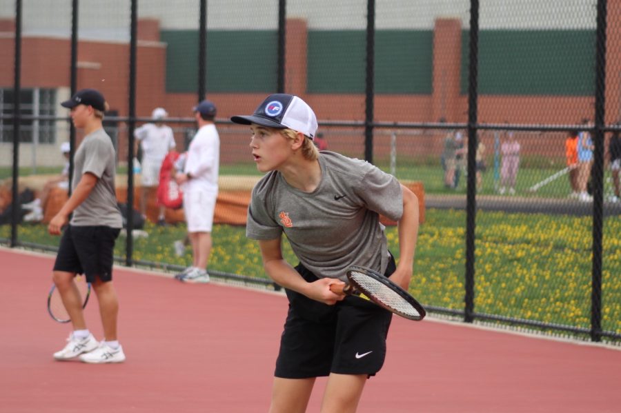 Sophomore Crew Lund hits the ball to his opponent at one of the teams final matches before sections. The match against Orono on May 11 ended in a loss of 6-1.