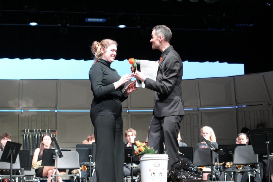 Senoir Rose Huse accepts a rose onstage May 9. Band director Steve Schimtz gave each senior a commemorative speech and handed them roses. 