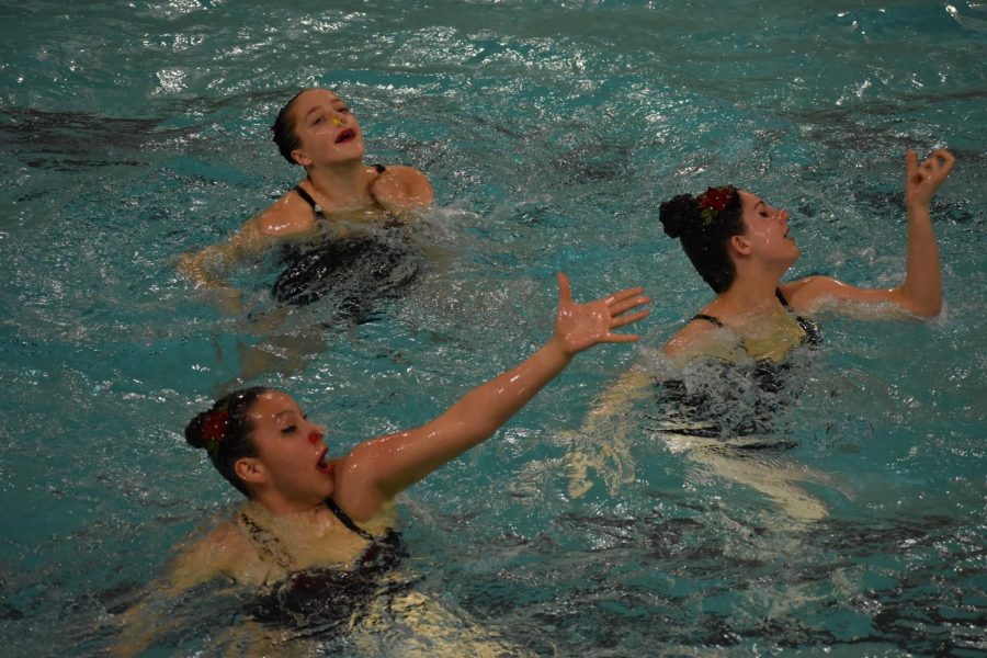 Middle-school swimmers Lauren Hoag, Elena Mutchler and Saya Quezada-Valdez perform their routine May 17. Each synchronized swimmer performed in multiple routines throughout the event.
