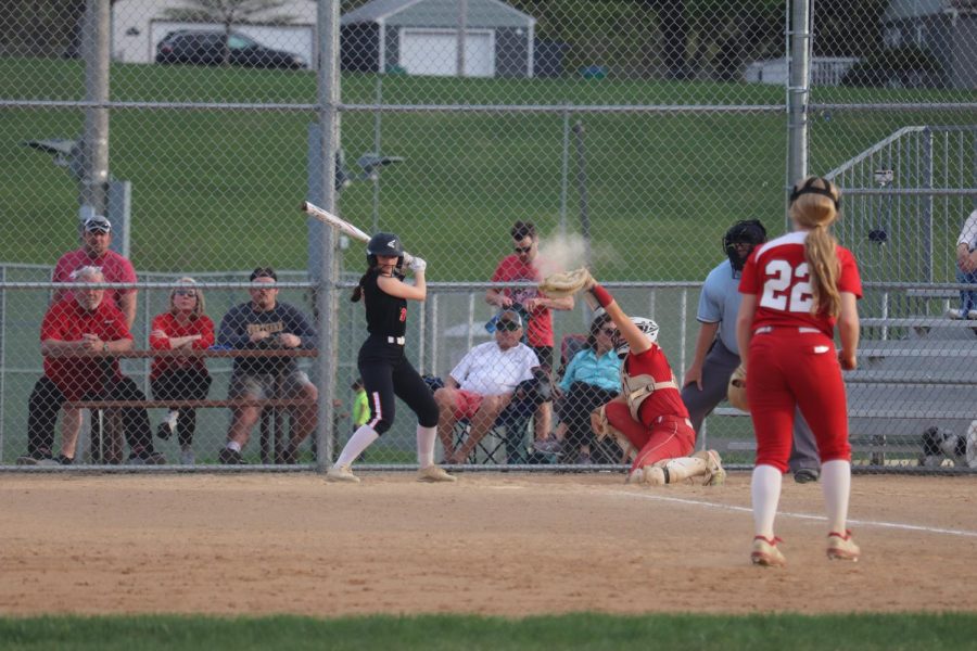 Sophomore Rowan Jansen at bat as the ball soars past her. The Orioles’ softball team played the Red Knights in their 11-9 win May 10. 