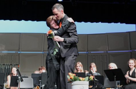 Senoir Ben Duncan embraces band director Steve Schmitz onstage. The wind ensemble had its final concert of the year on May 9.