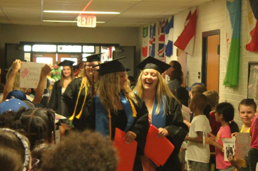 Kids congratulate Park seniors while holding signs with senior’s names May 31. The seniors commemorated their graduation by holding a senior walk through elementary schools Wednesday.
