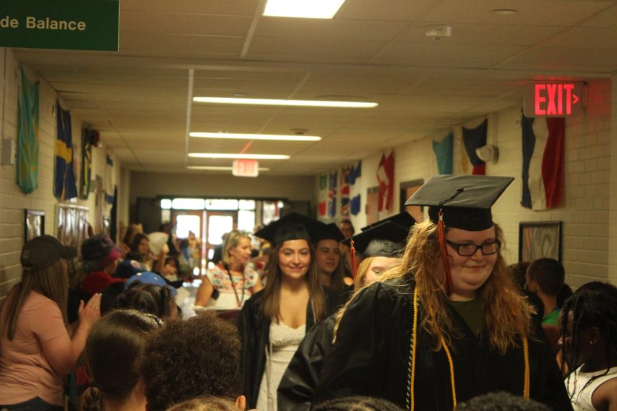 Seniors look around at elementary students May 31. The seniors commemorated their graduation by holding a senior walk through elementary schools Wednesday.