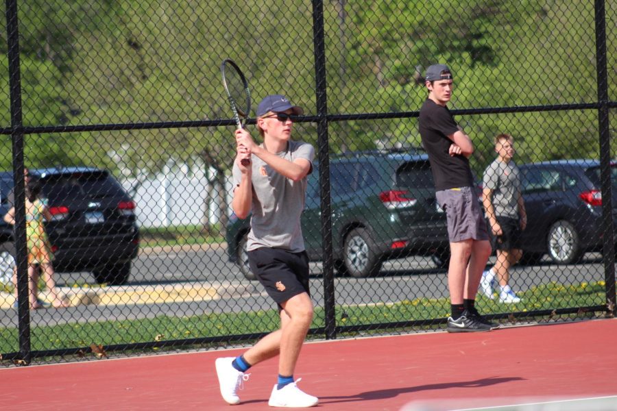 Sophomore Thomas Halverson plays the tennis ball over the net to his opponent May 15. Halverson won against his opponent from Minneapolis South, leading to the teams overall win of 5-2.