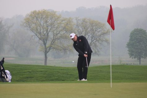 Junior Landyon Tasto prepares to putt the ball into the hole May 18. Golf had a non-conference meet at Bremer Golf field where they beat Eden Prairie by one stroke.